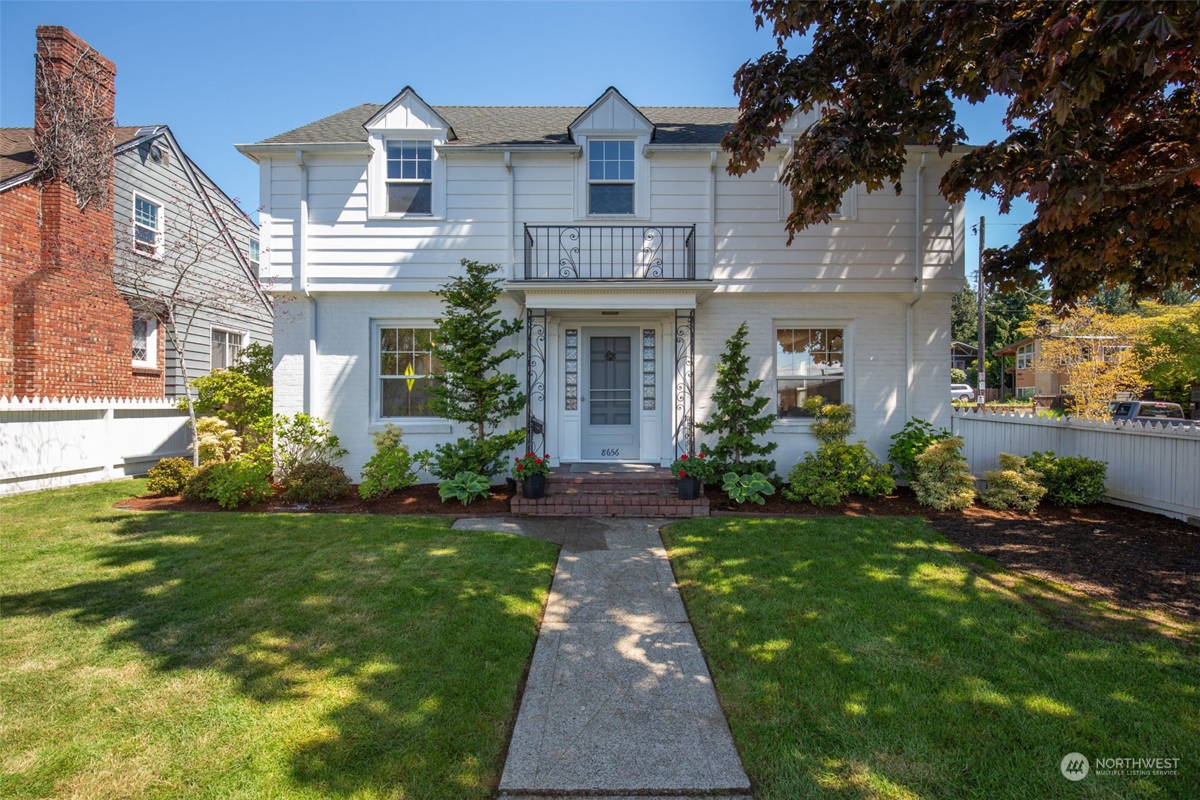 a front view of a house with a garden