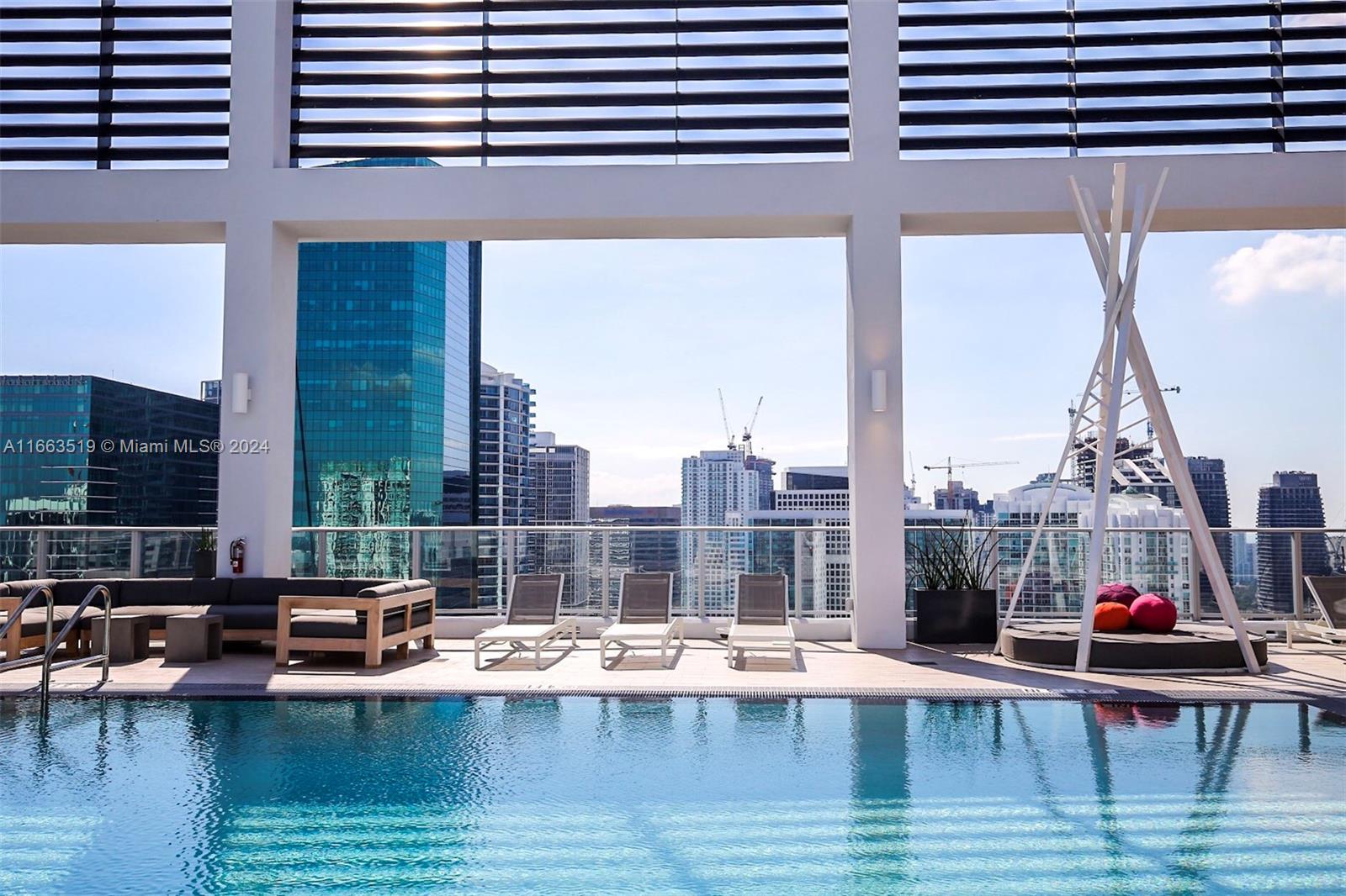 a view of swimming pool with outdoor seating