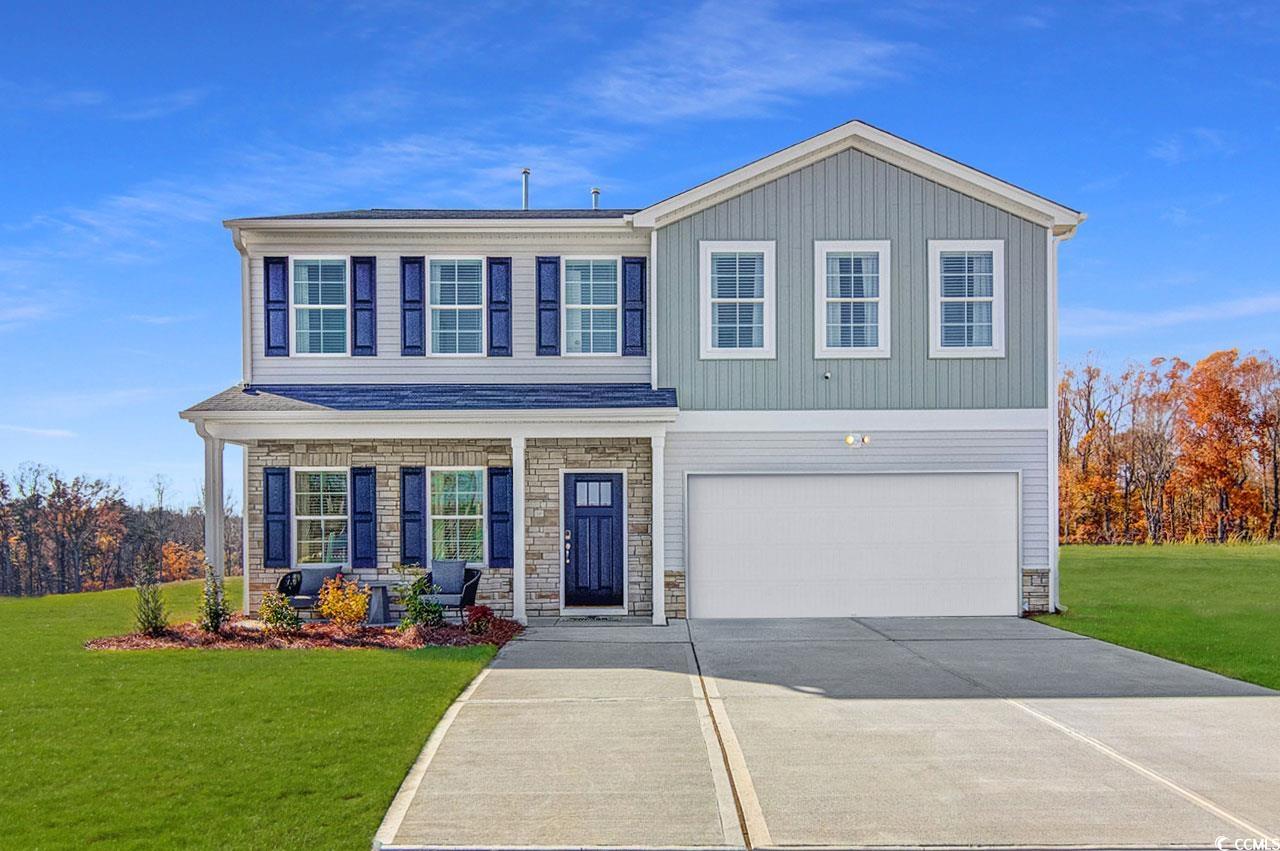 View of front of house featuring a garage and a fr