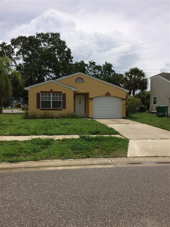 a front view of house with yard and green space