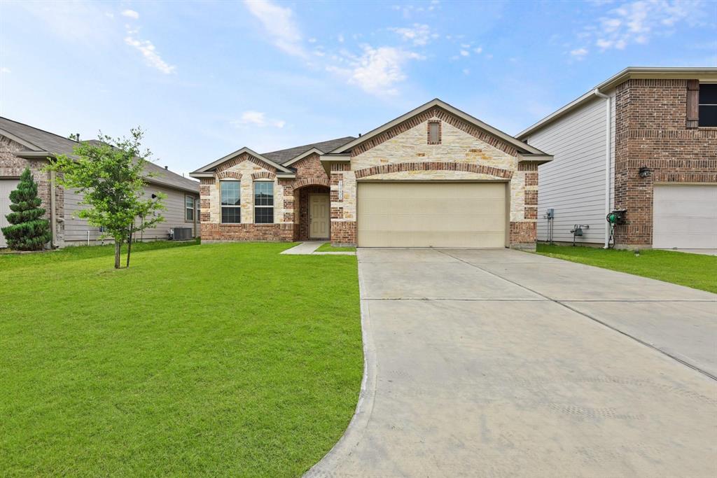 a view of a house with a yard and garage