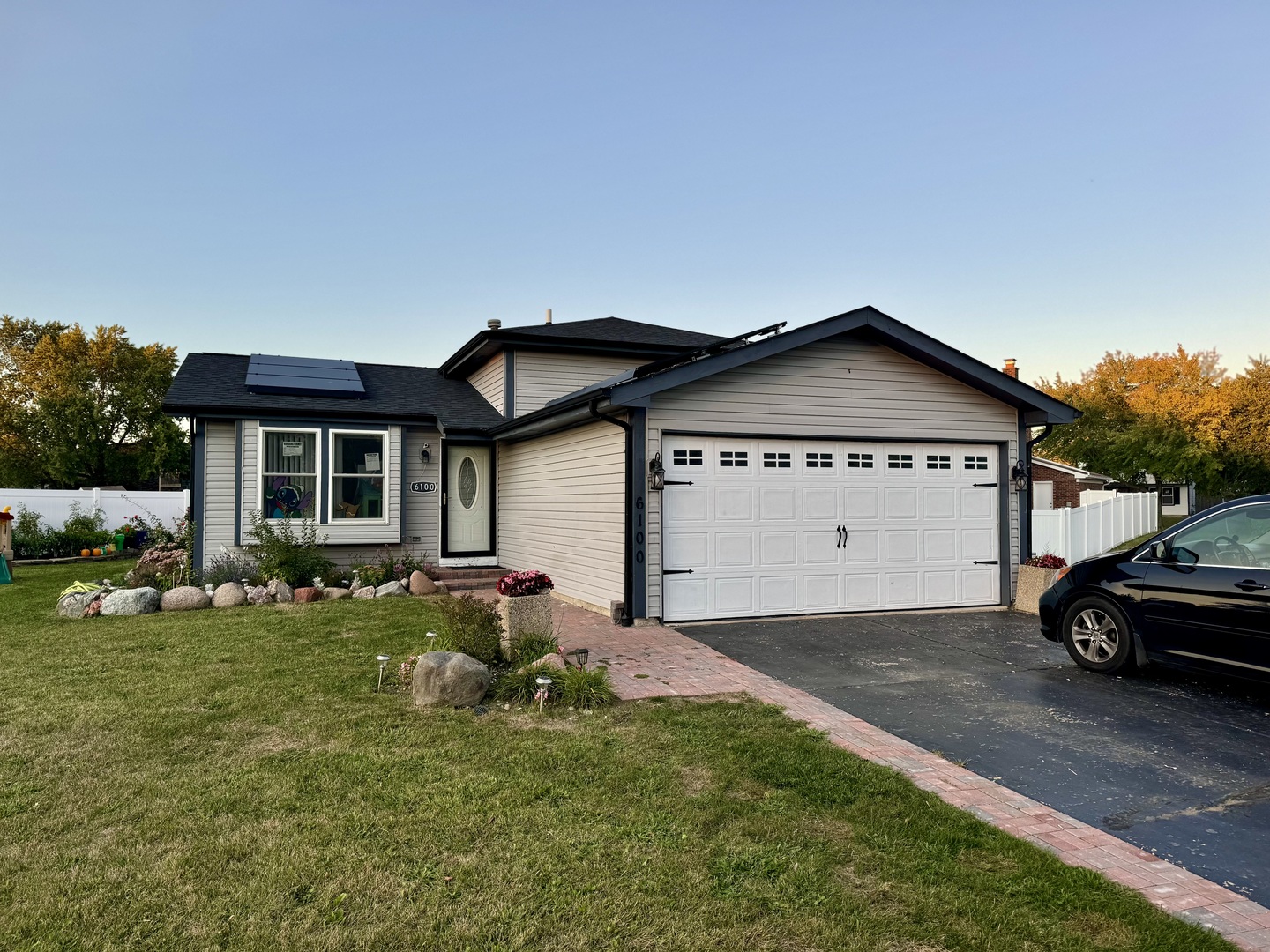 a view of front of a house with a yard and garage