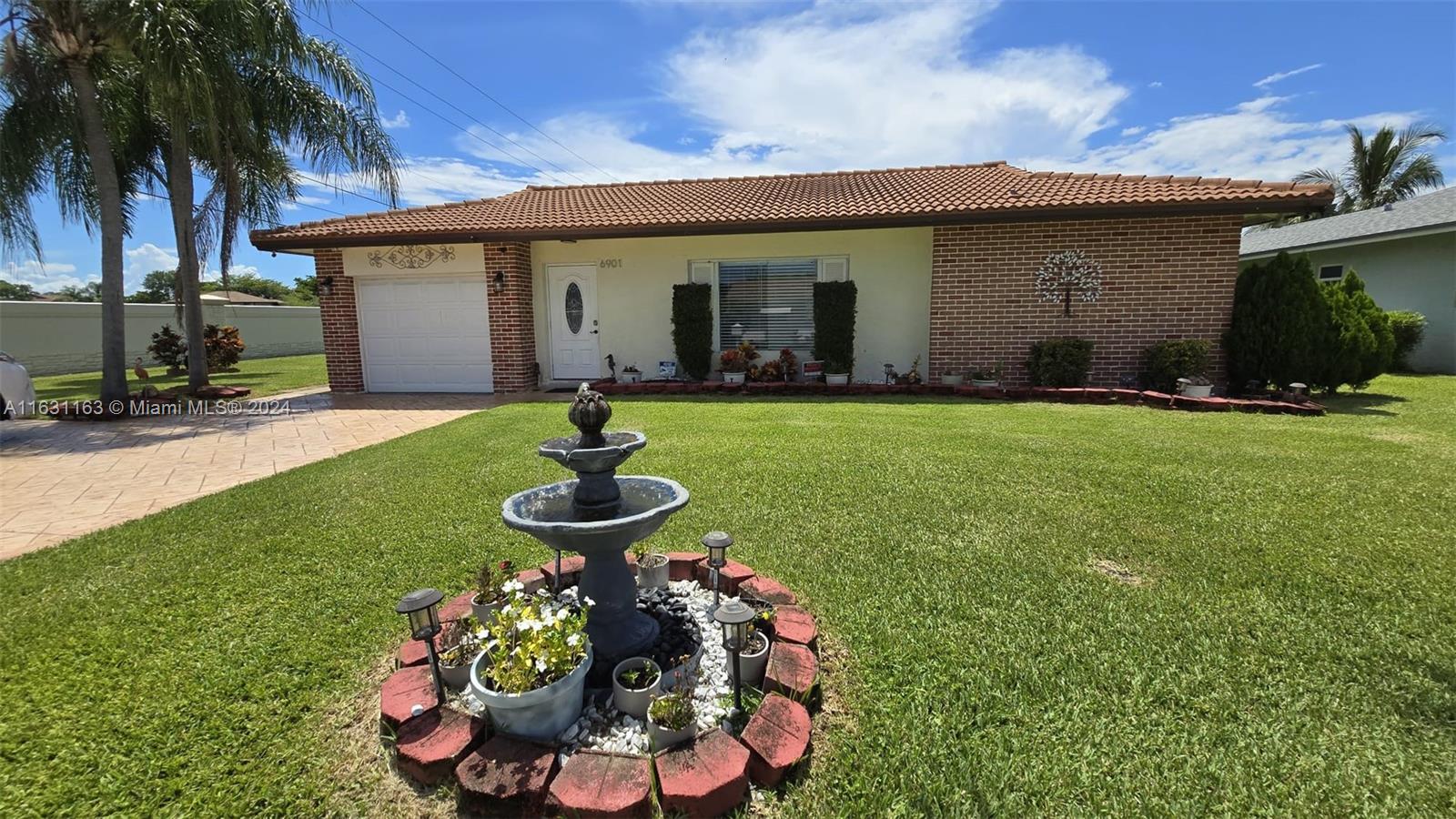 a front view of house with yard and outdoor seating