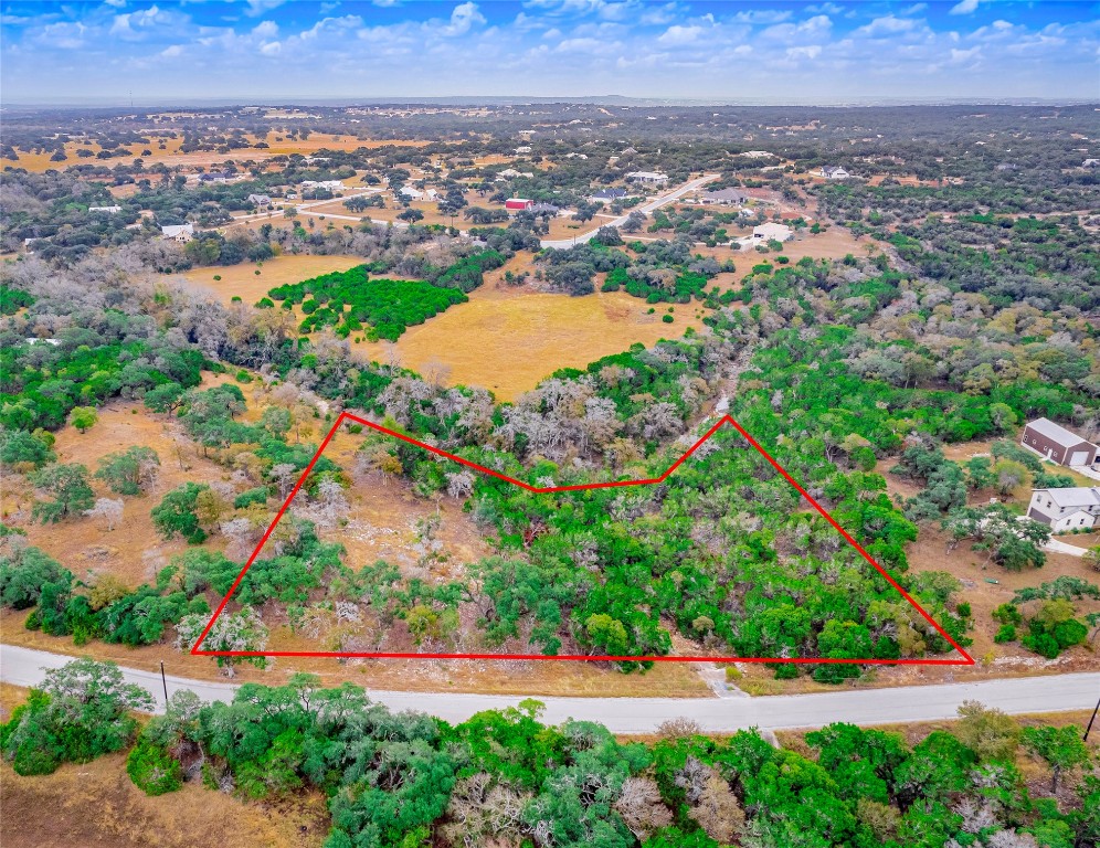 an aerial view of residential building and trees around