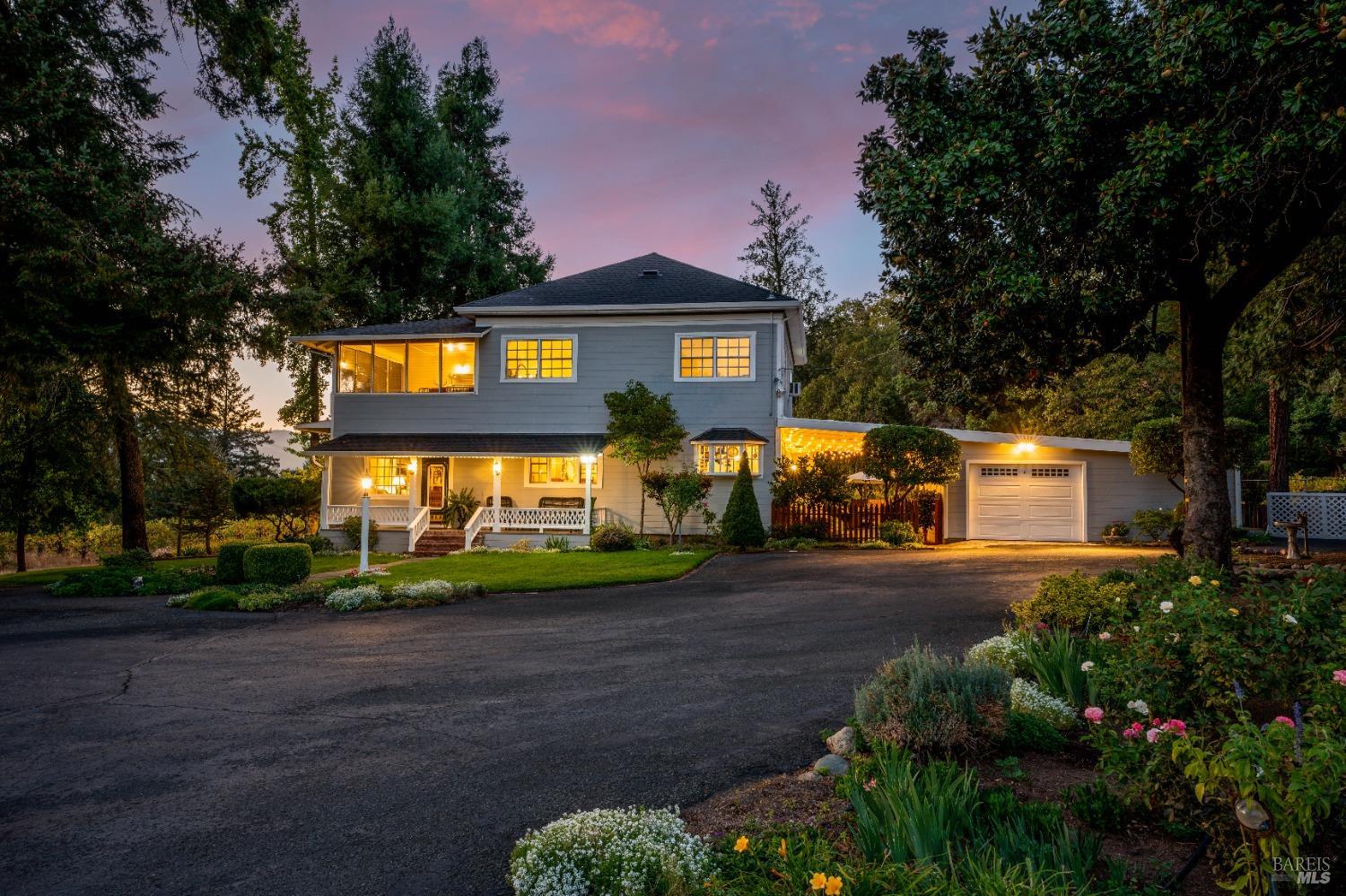 a front view of a house with a yard and outdoor seating