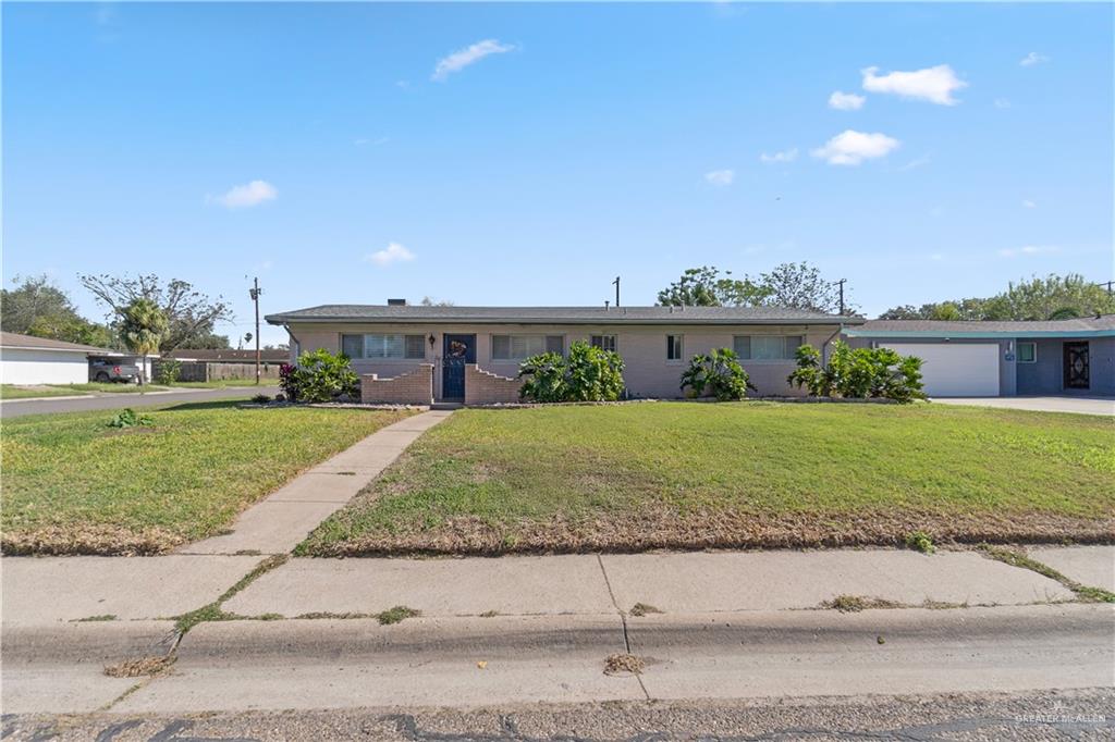 Single story home featuring a front lawn and a garage