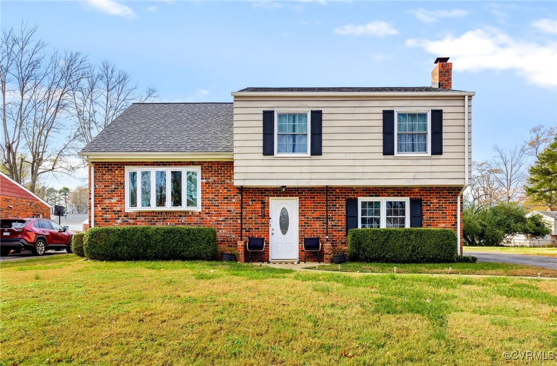 View of front of house with a front yard