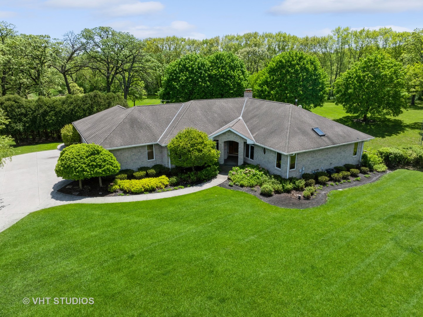 a view of a house with a yard and green space