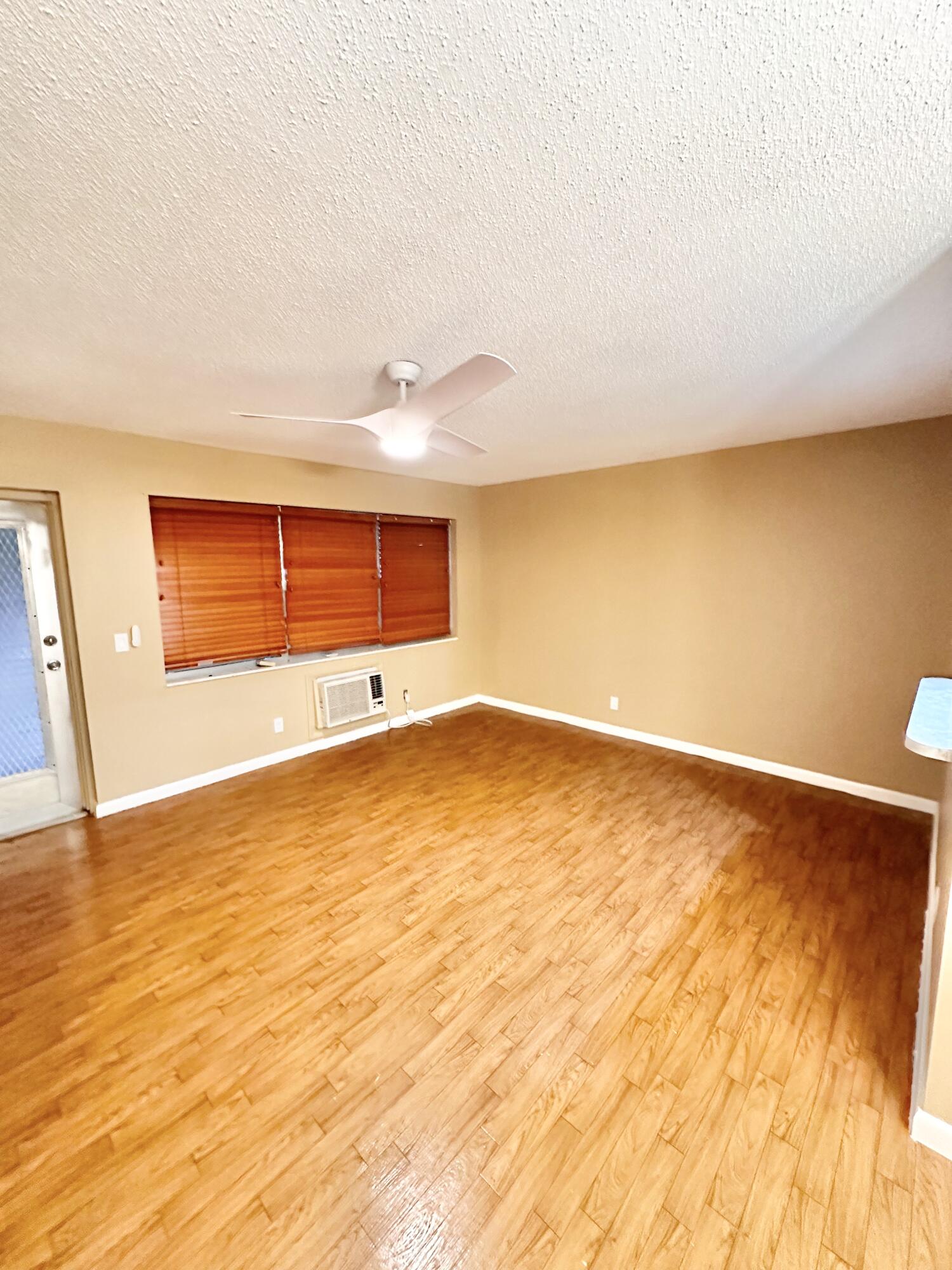 a view of an empty room and wooden floor