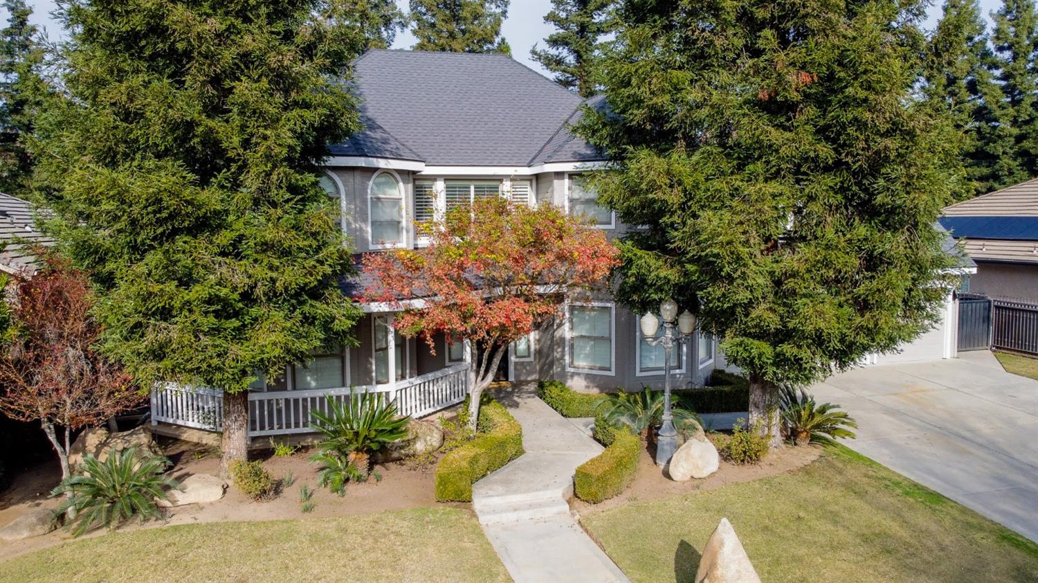 an aerial view of a house with yard and trees