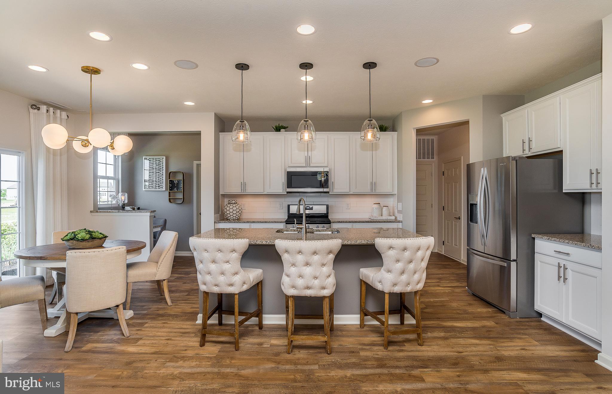 a large kitchen with a table and chairs