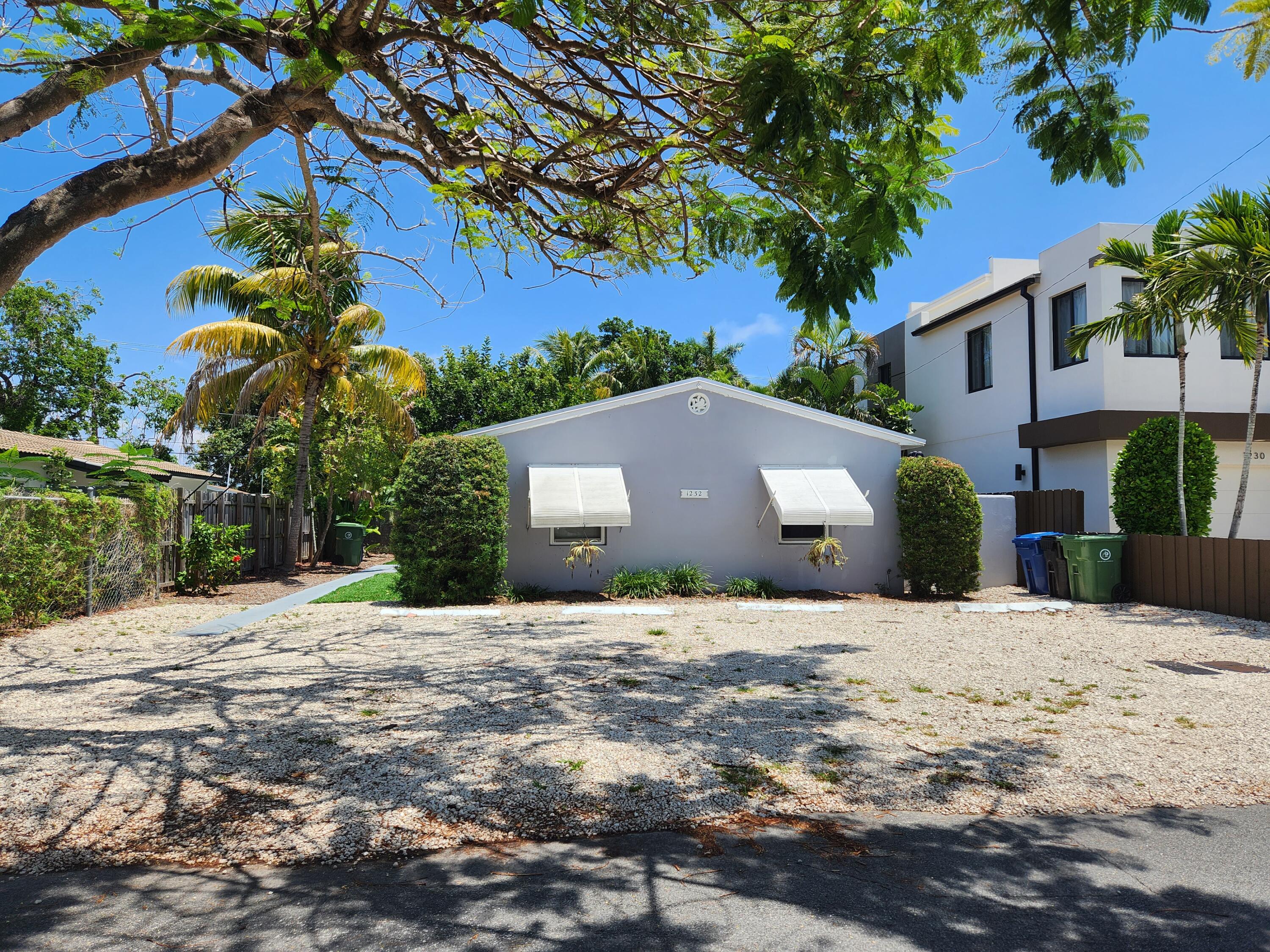 a house with tree in front of it