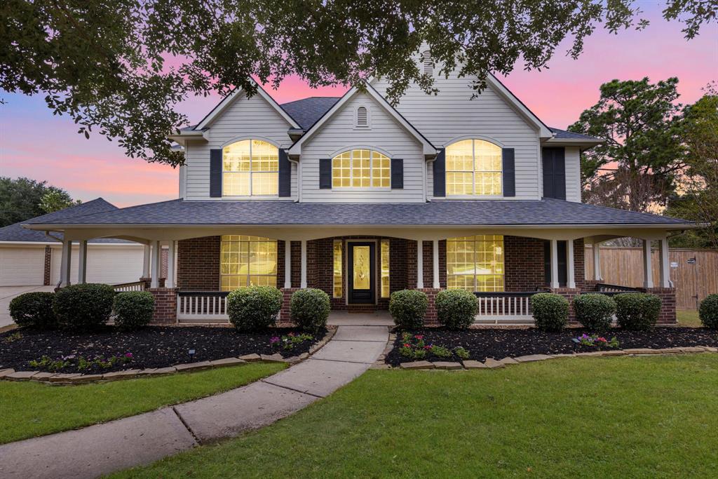 a front view of a house with porch and garden