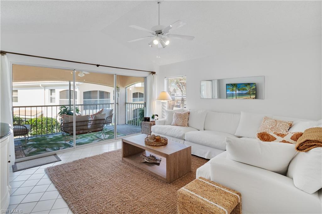 a living room with furniture and a floor to ceiling window