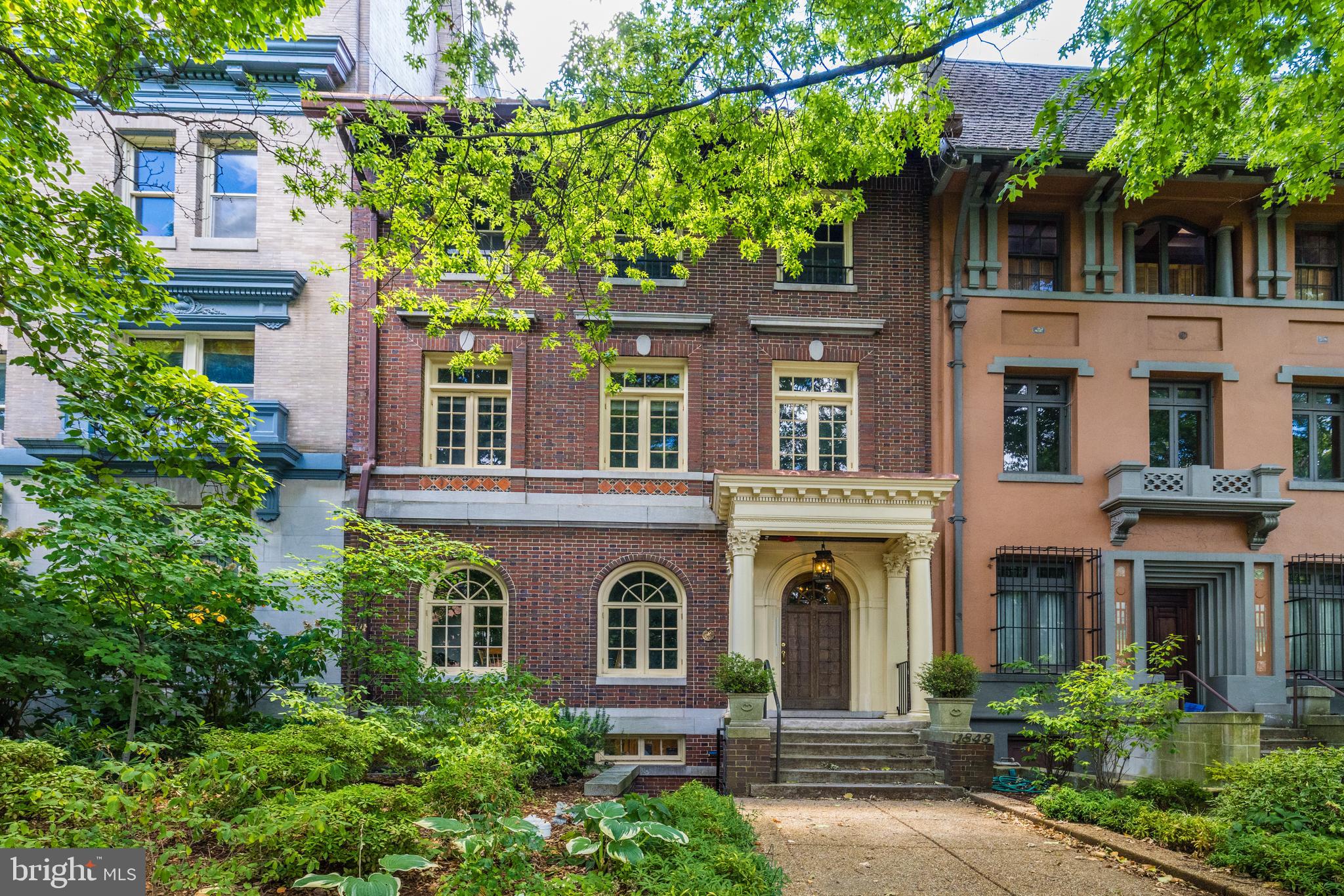 front view of a brick house with a large windows