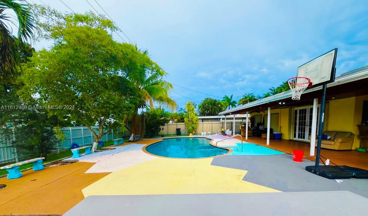 a view of a house with swimming pool and sitting area