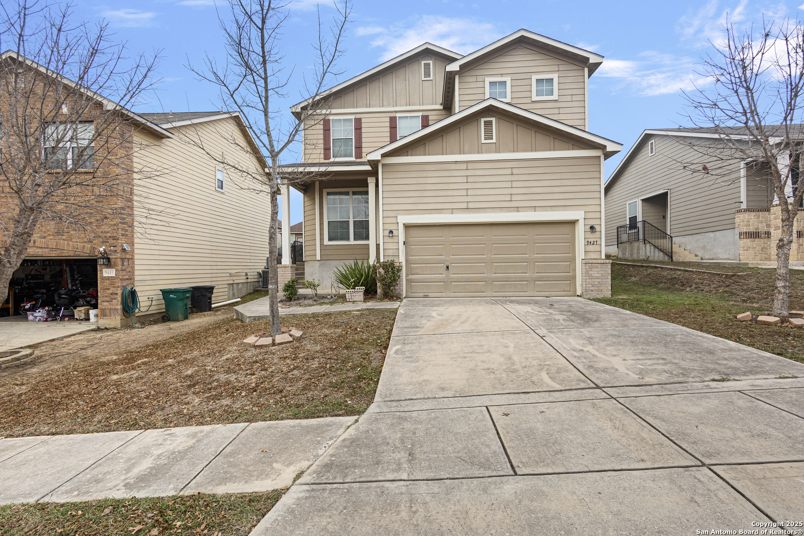 a front view of a house with a yard and garage