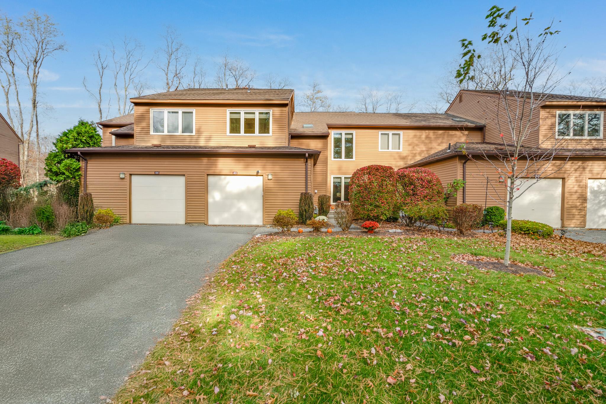 View of front of property featuring a front yard and a garage