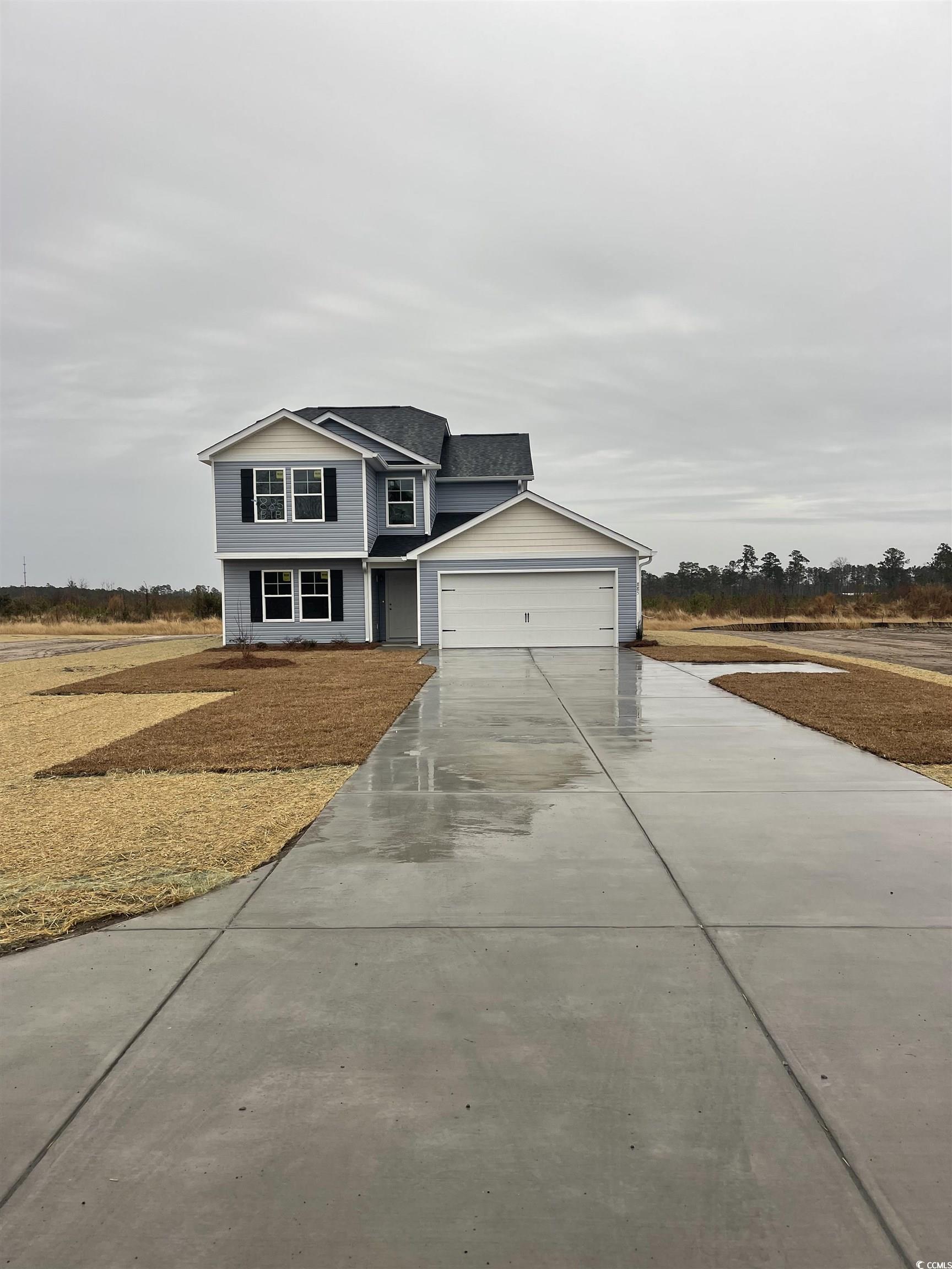 View of front facade featuring a garage