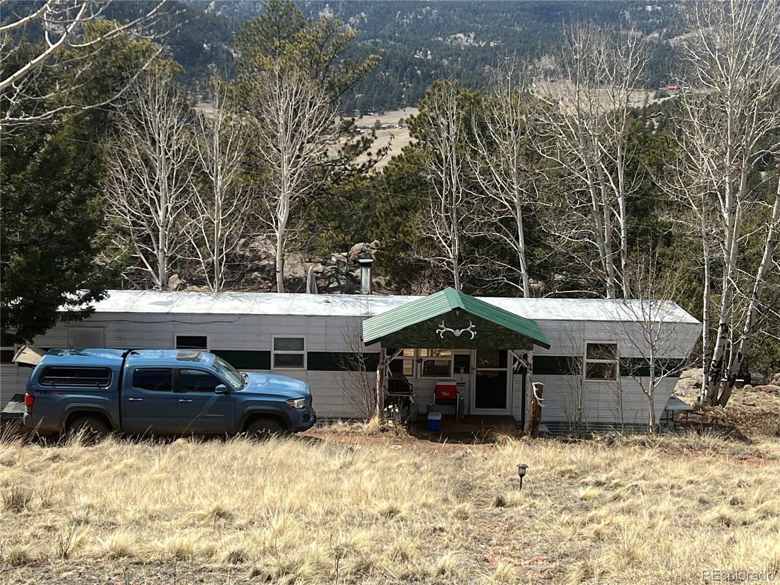 a front view of a house with cars parked