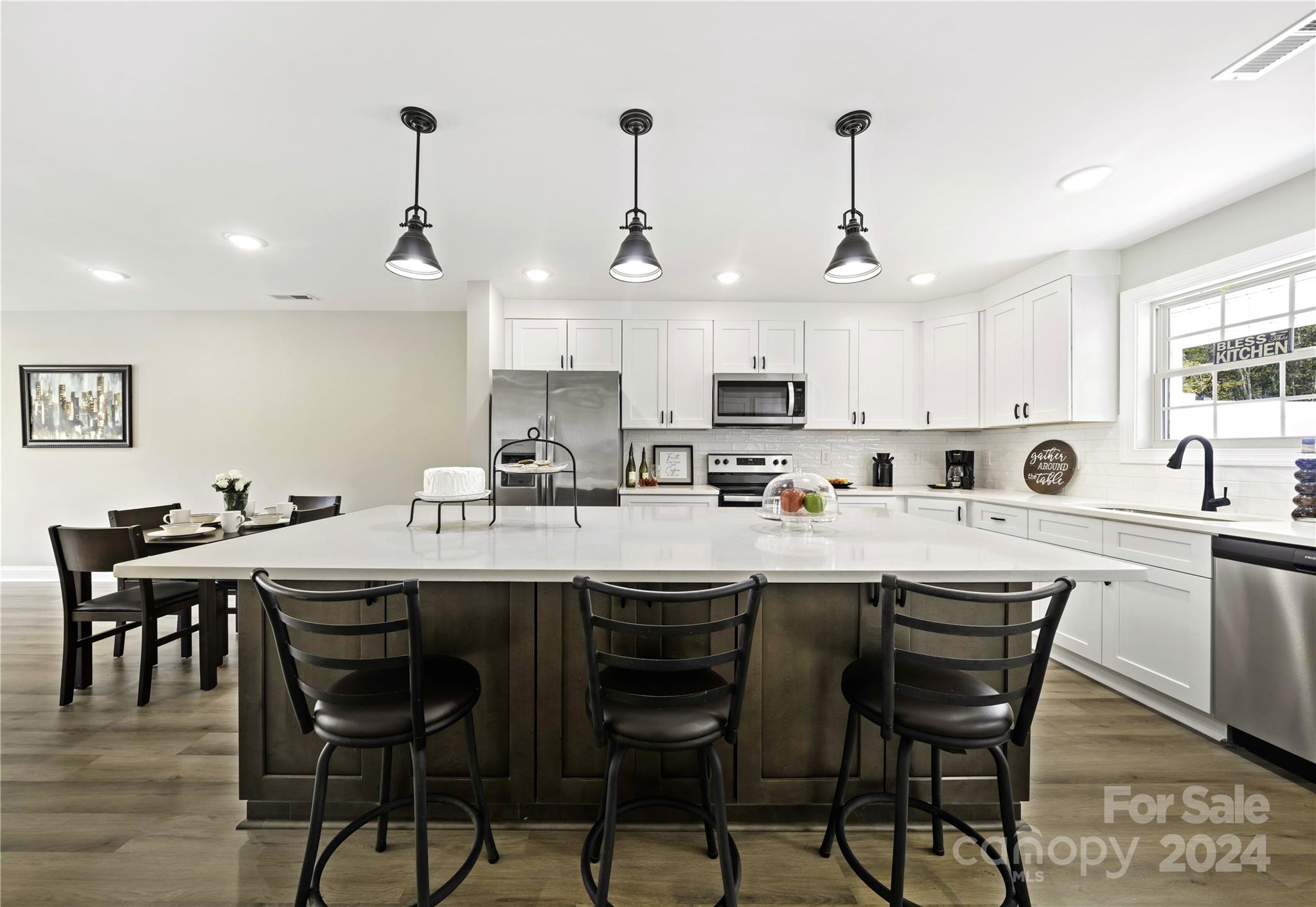 a kitchen with a sink and chairs