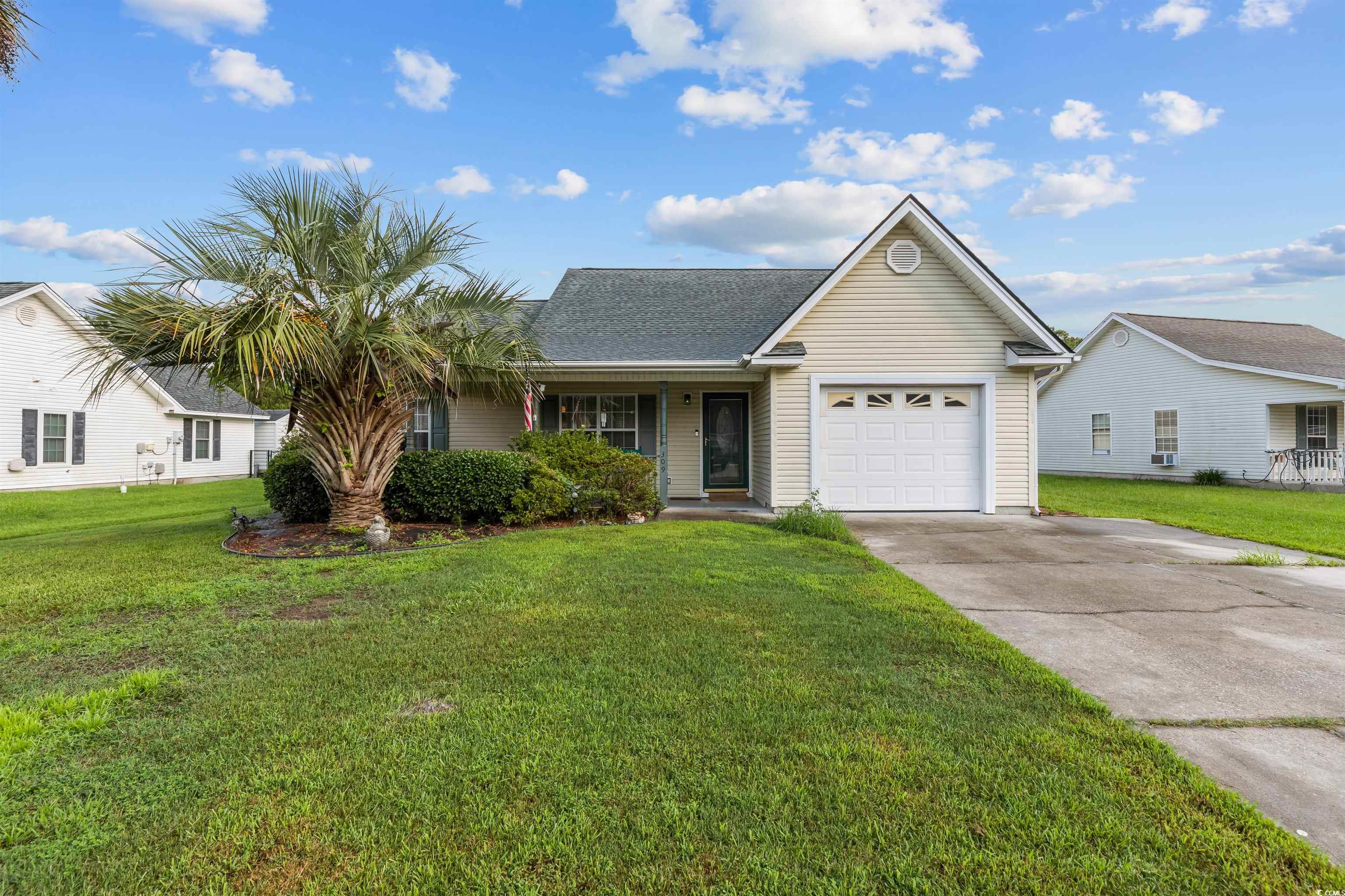 Ranch-style home with a garage and a front yard