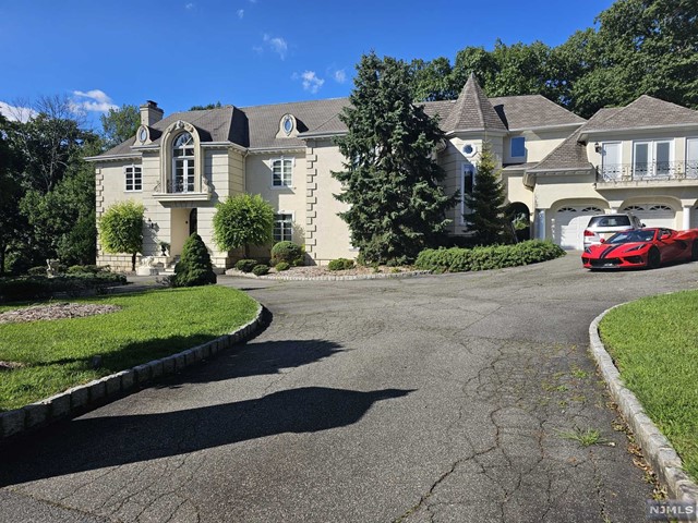 a front view of a house with a yard and outdoor seating