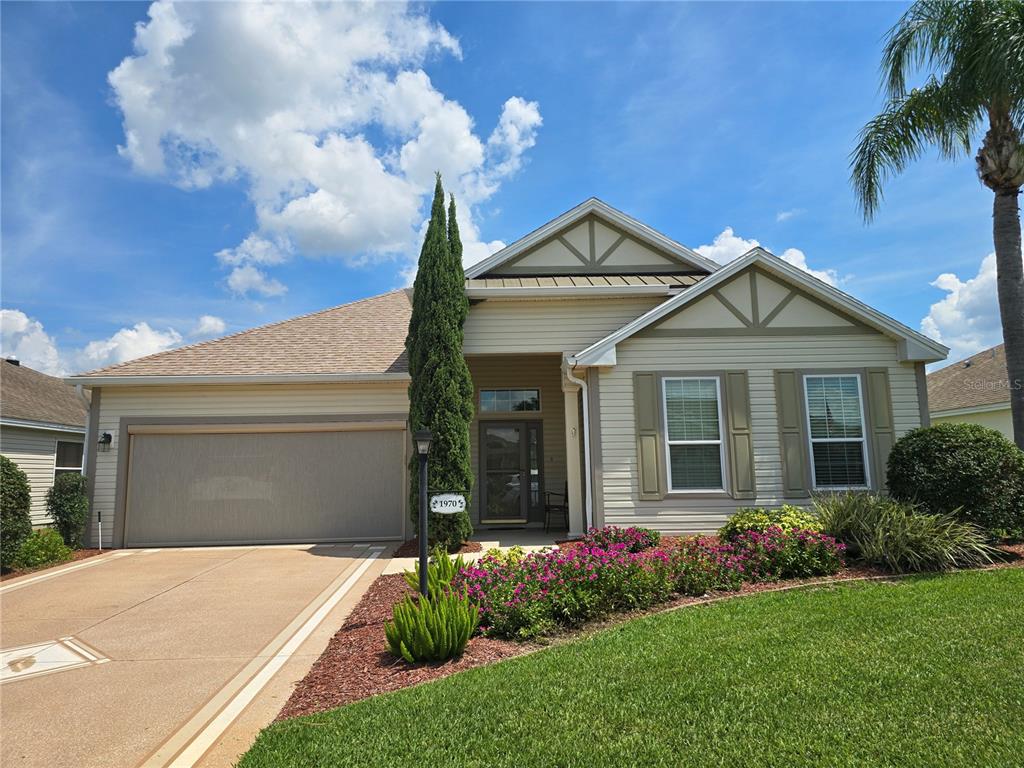 a front view of a house with a garden