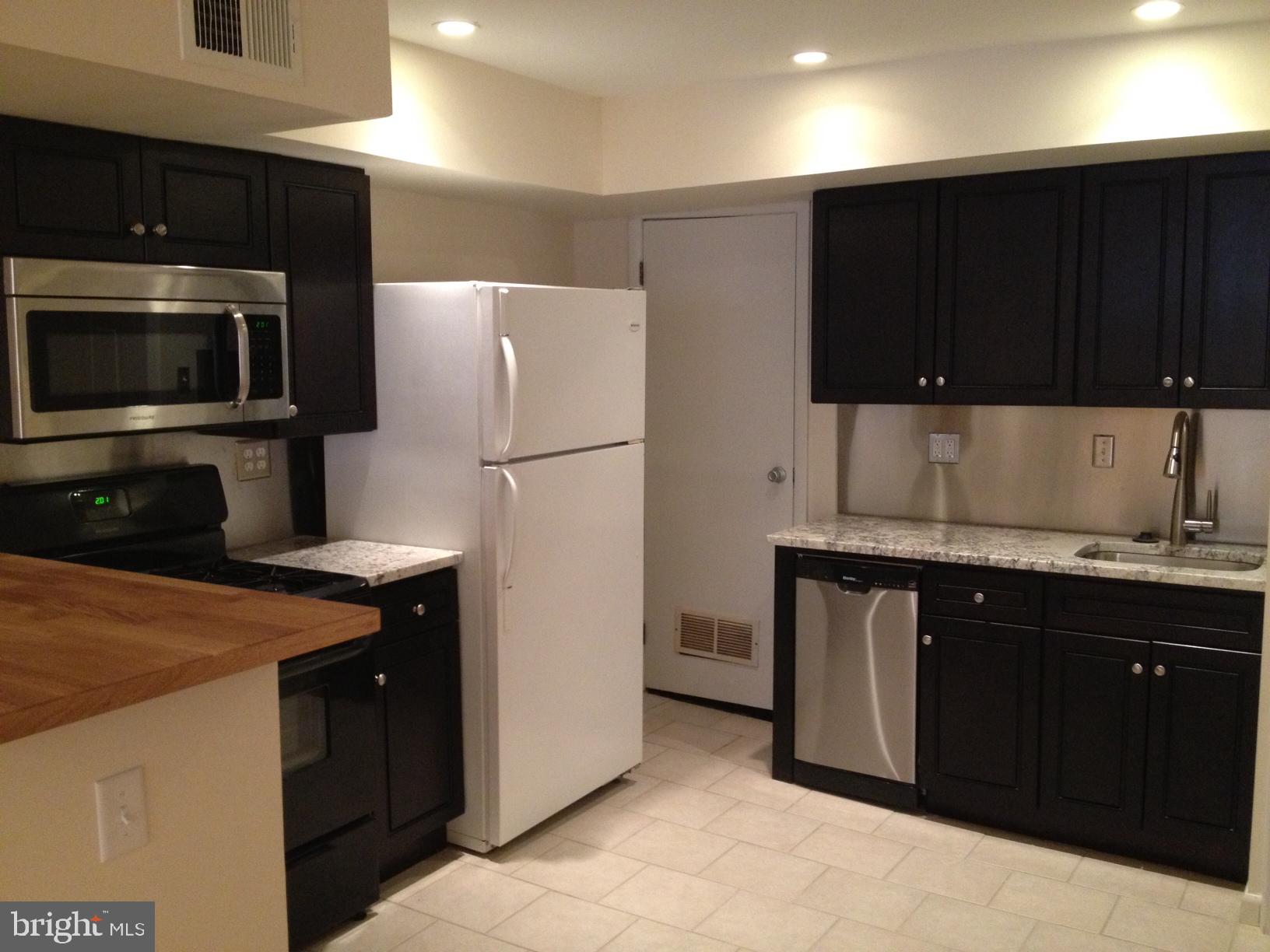 a kitchen with a sink a stove and refrigerator