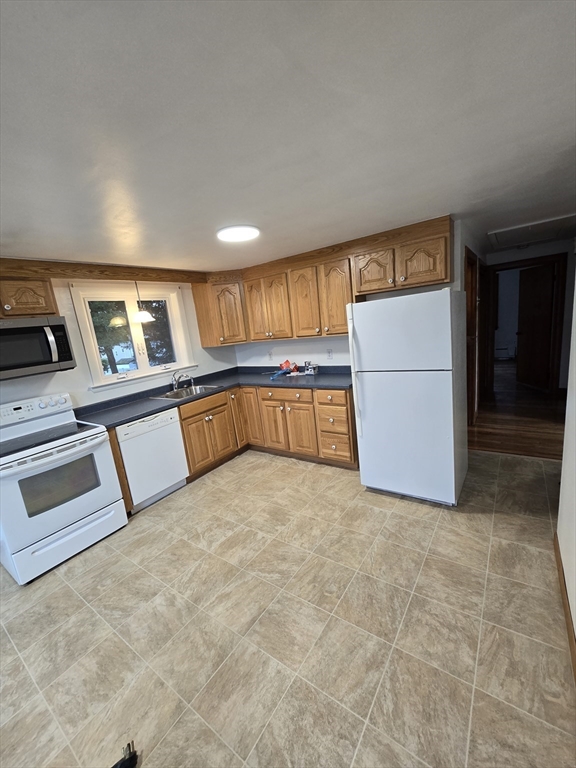 a view of kitchen with refrigerator and microwave