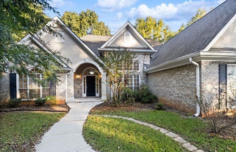 a front view of a house with garden