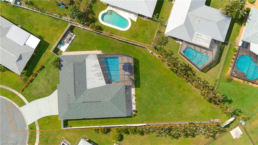 an aerial view of a house with a swimming pool