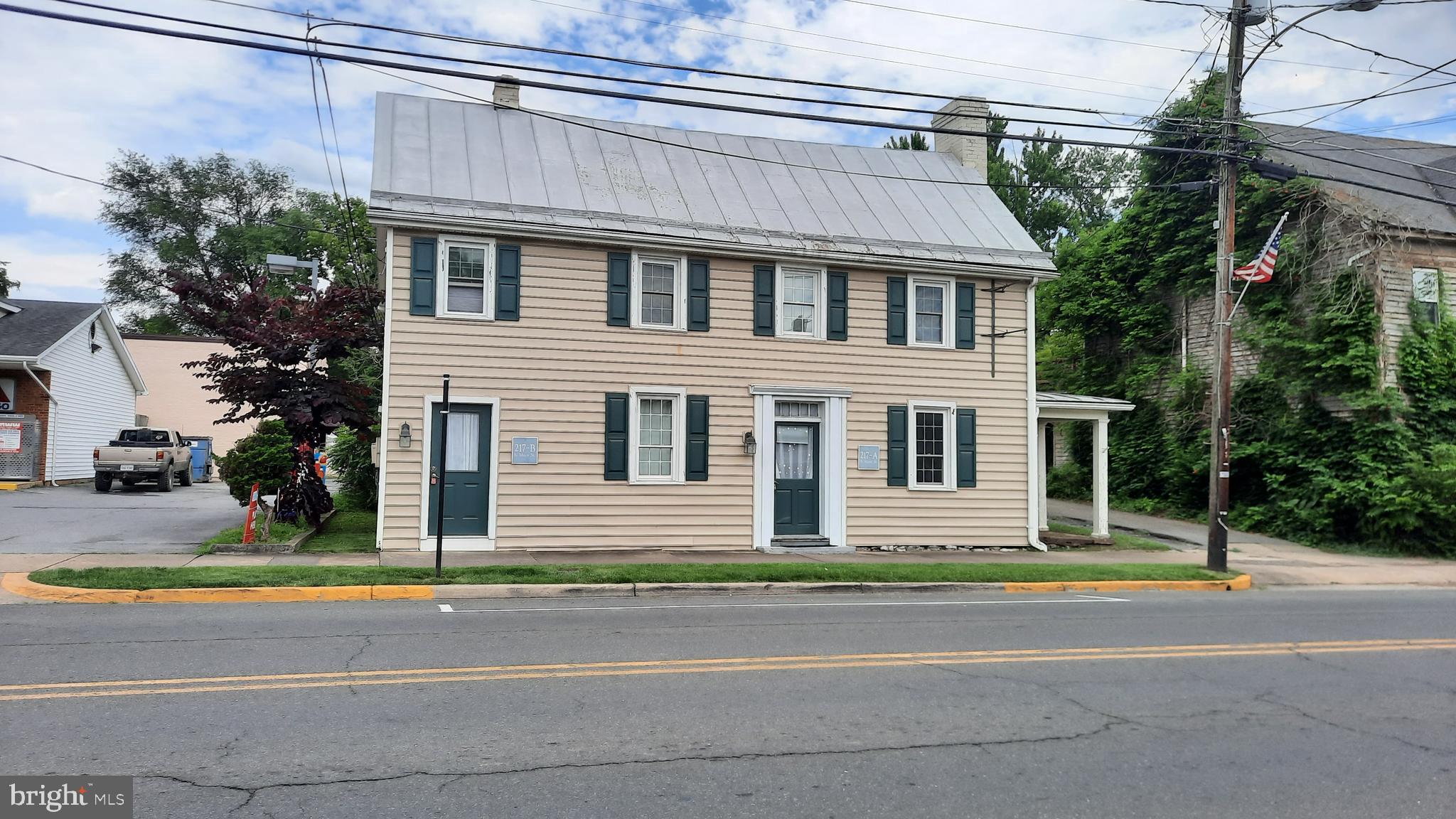 a front view of a house with a garden and garage