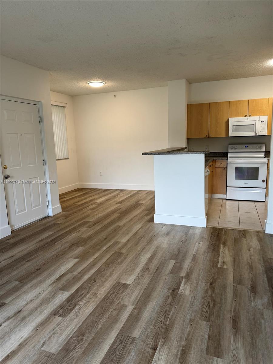 a view of kitchen with sink and microwave