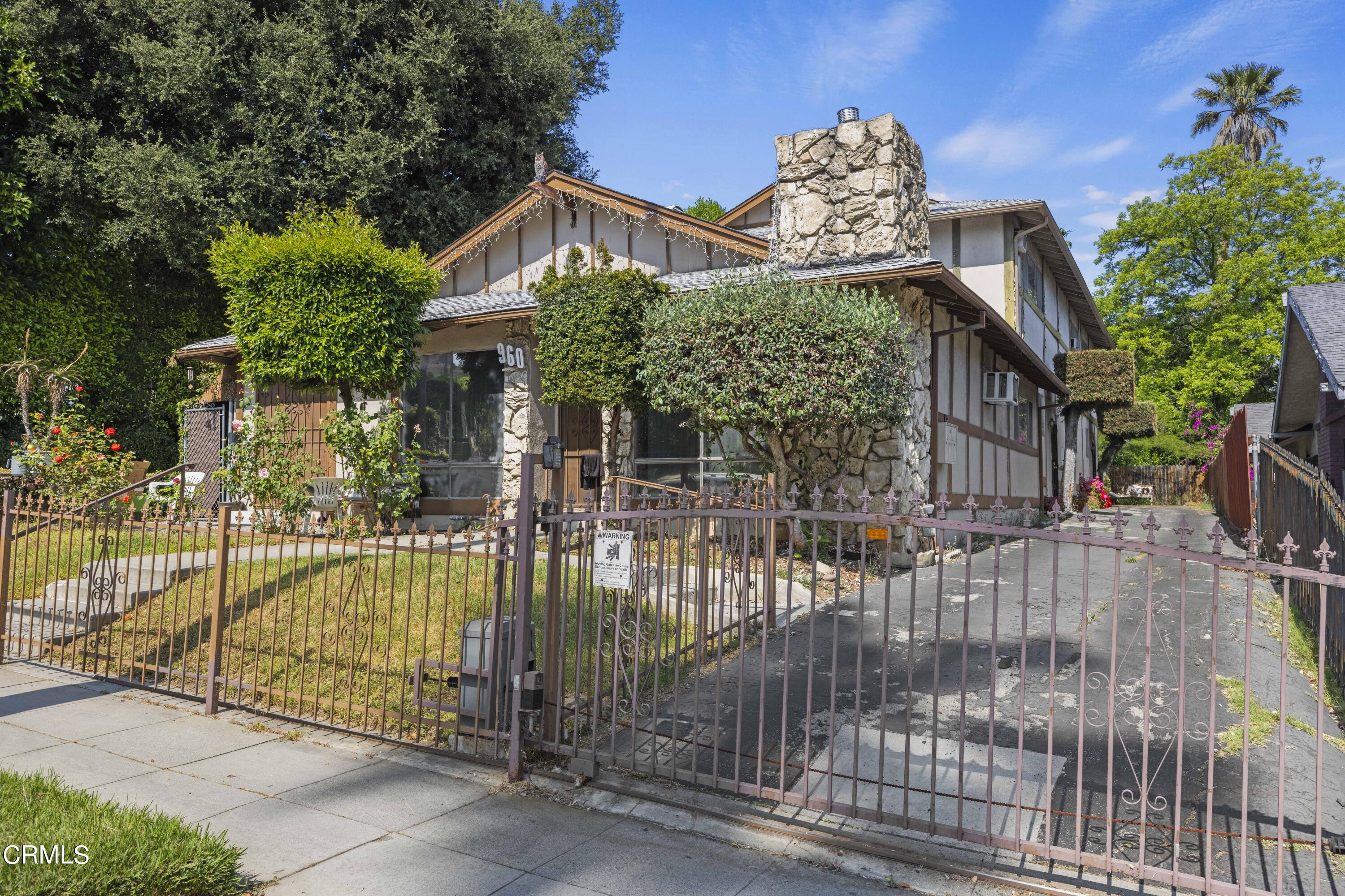 a view of a house with a iron gate