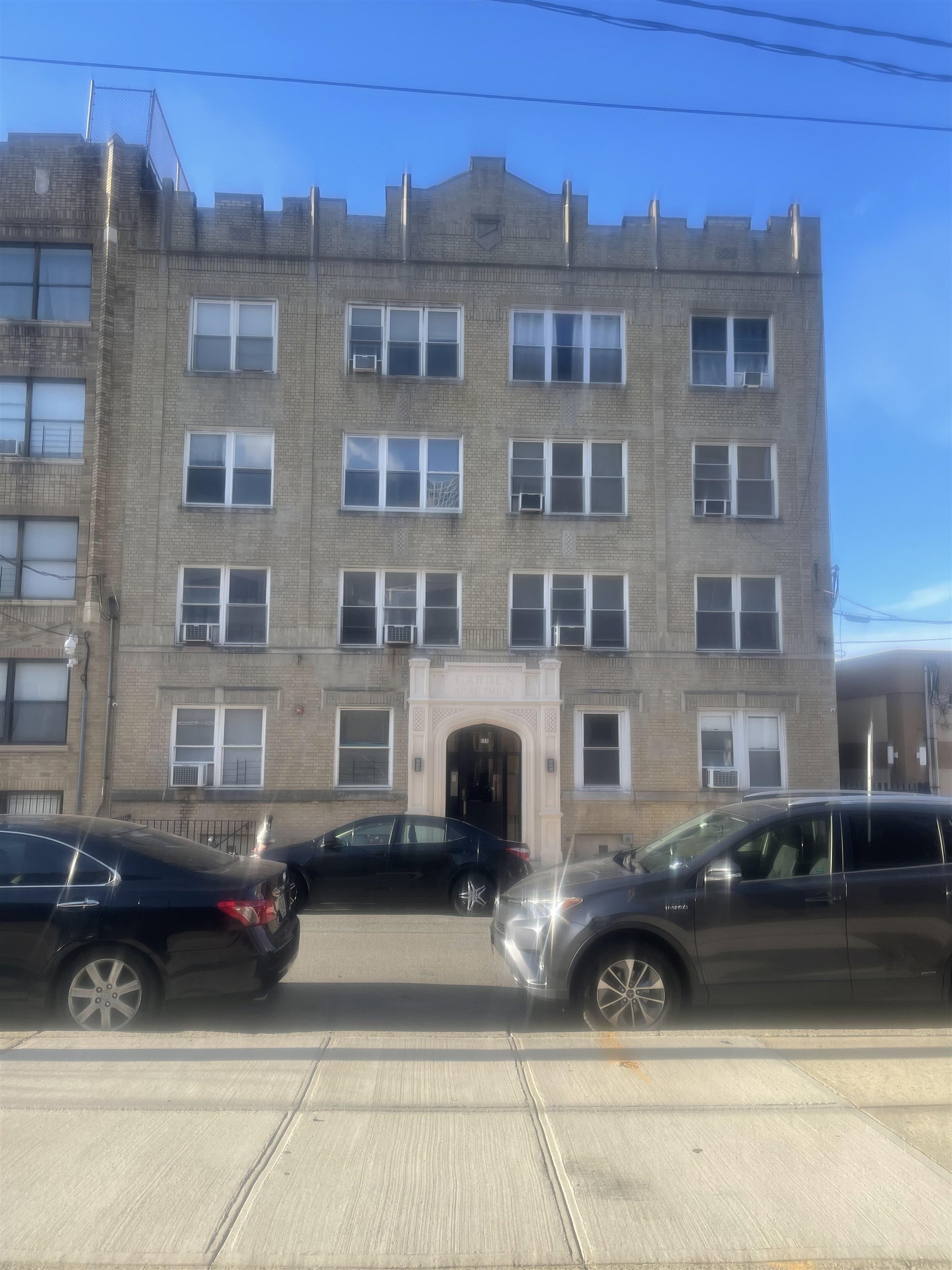 a black car parked in front of a building