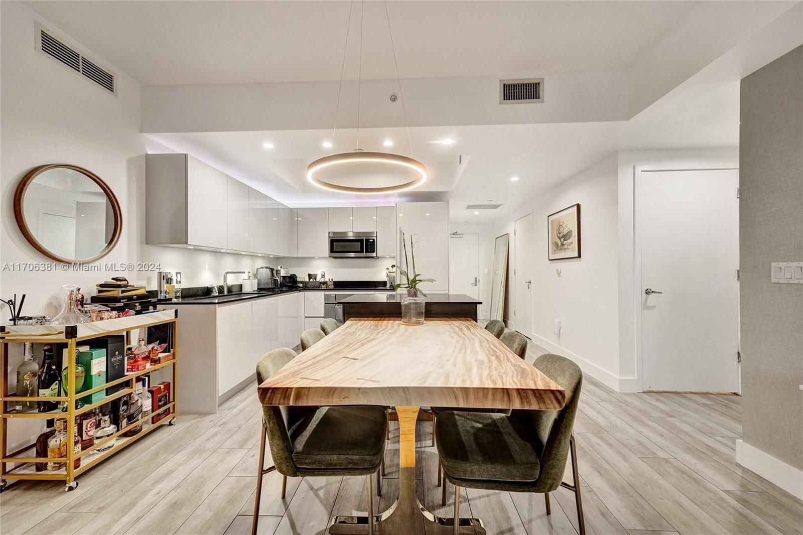 a large kitchen with a table and chairs in it