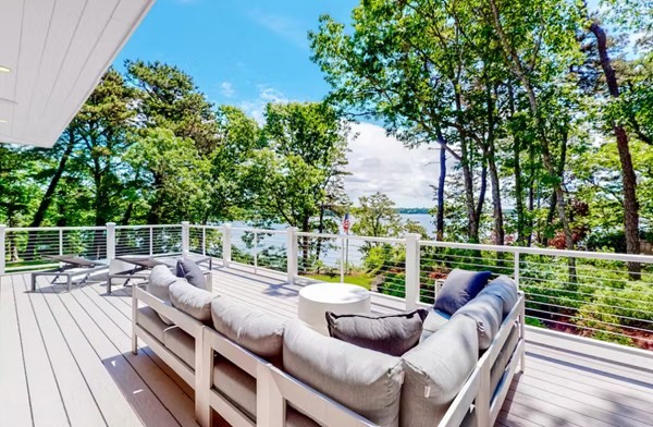 a balcony with wooden floor and fence