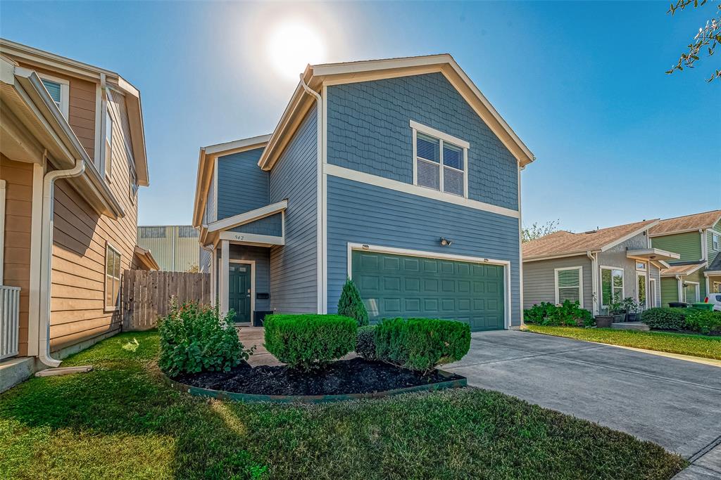 a front view of a house with a yard and outdoor seating