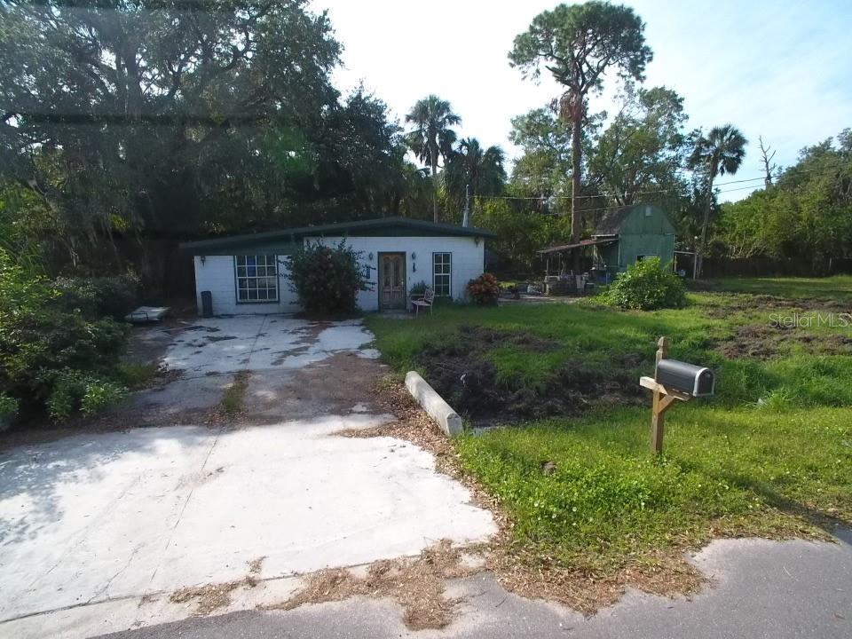 a view of backyard of house with outdoor seating and green space