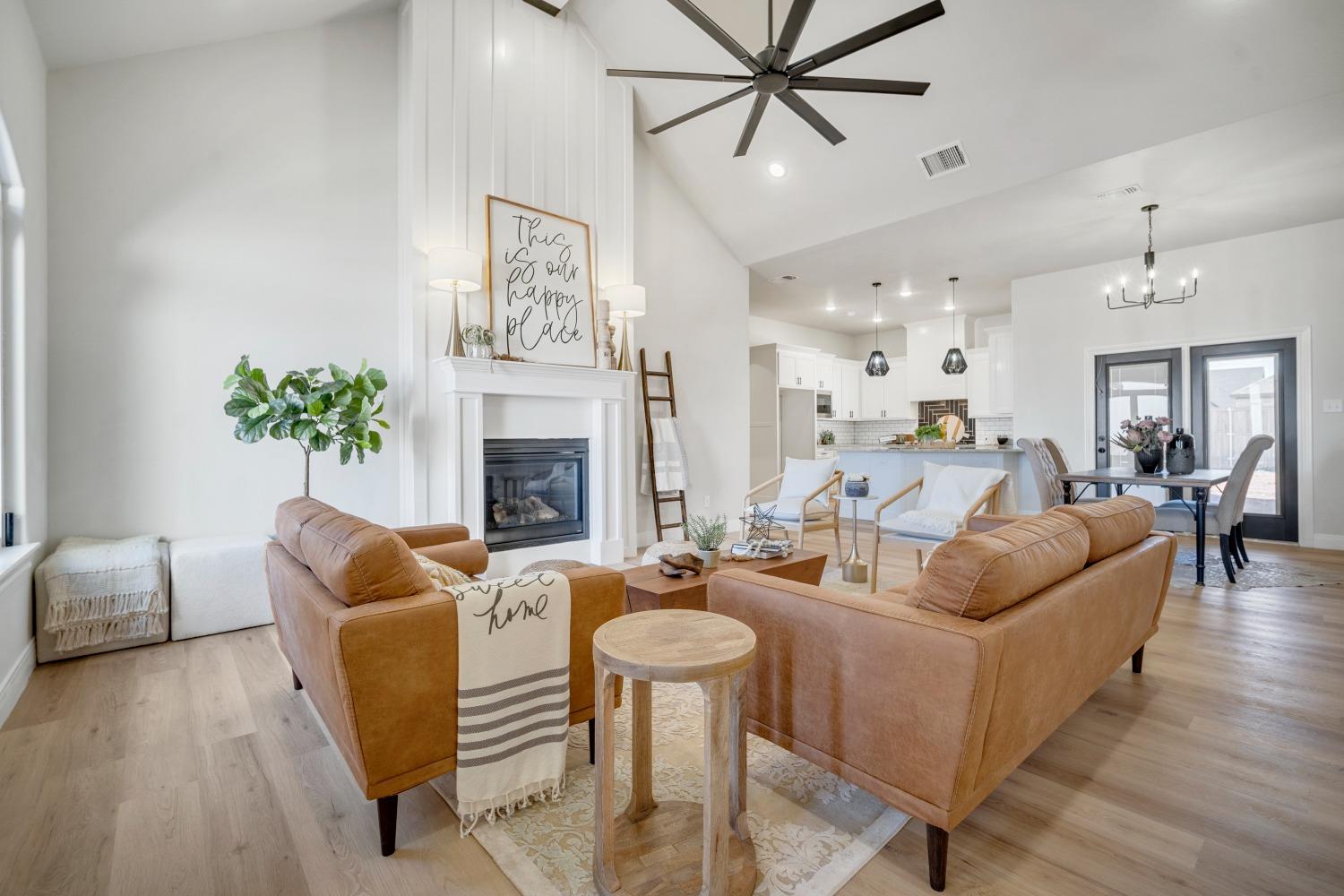 a living room with furniture a fireplace and a chandelier