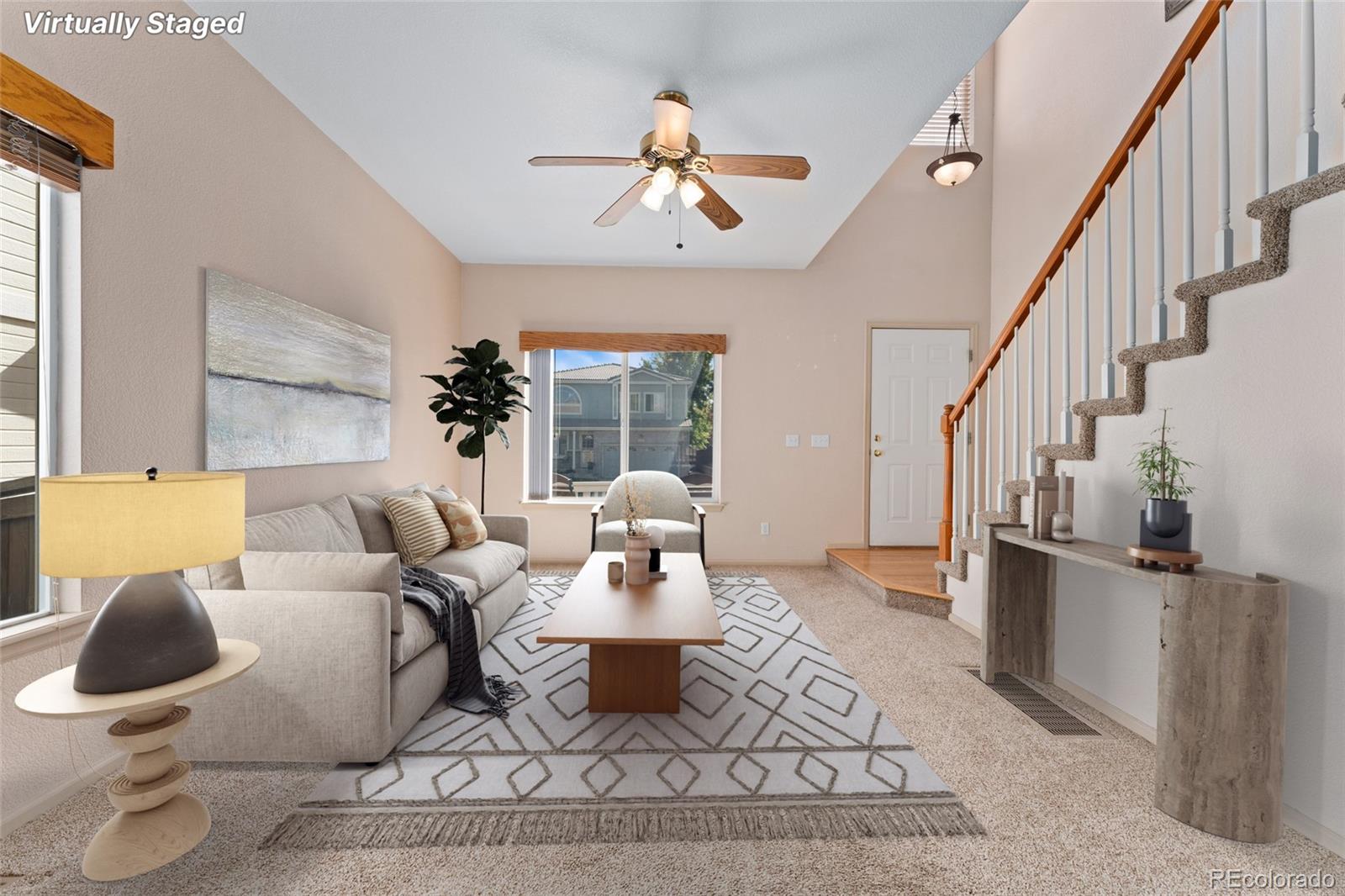 a living room with furniture a rug and a chandelier