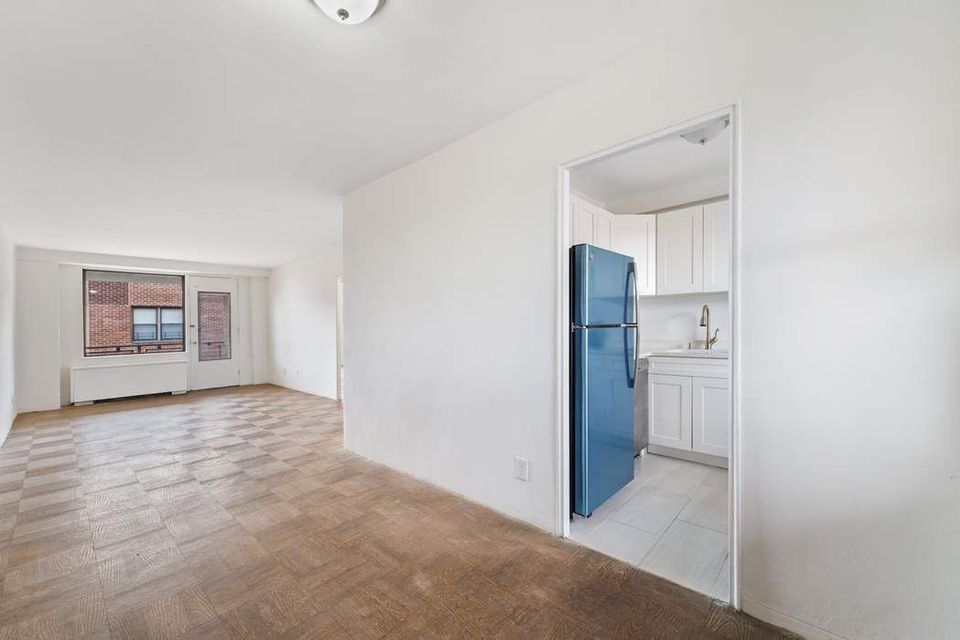 a view of a kitchen with refrigerator and sink