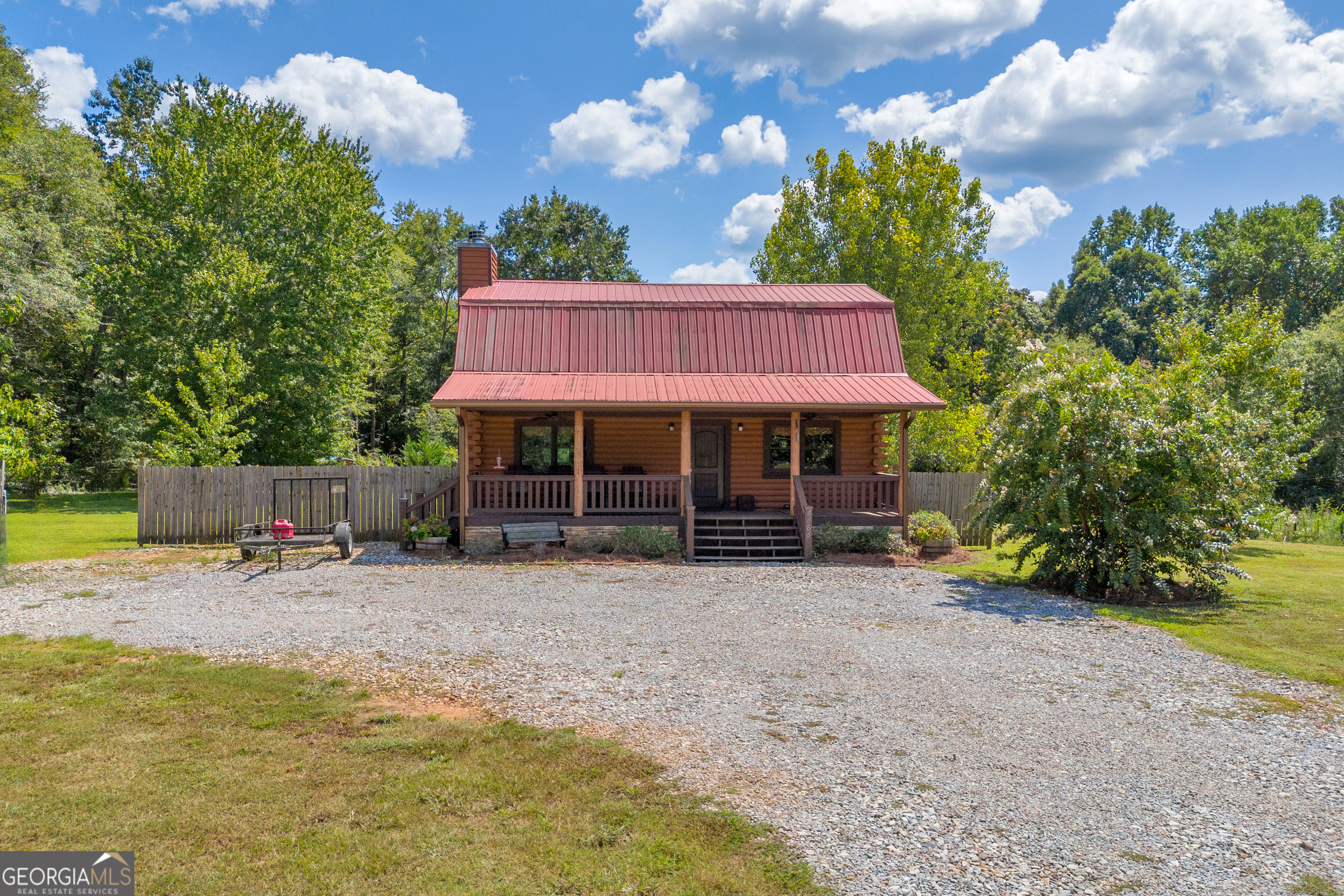 a view of a house with a yard and sitting area