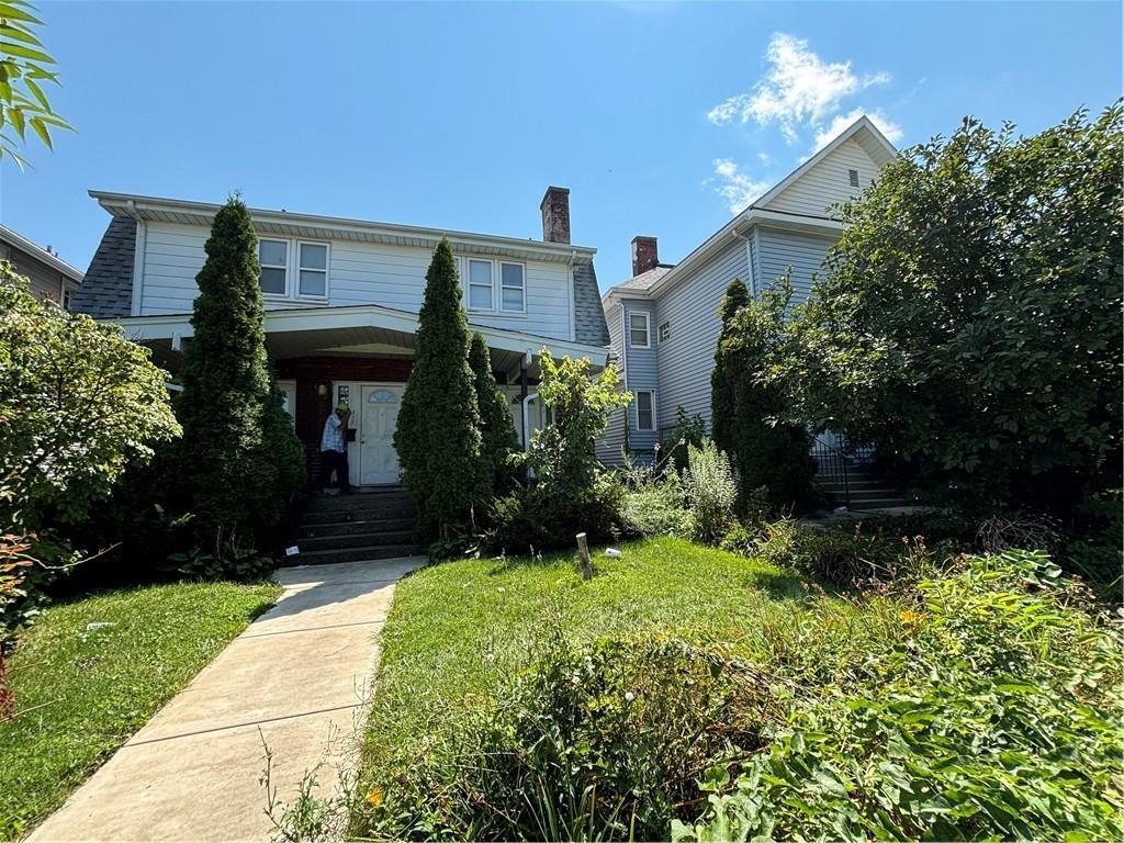 a front view of a house with a yard