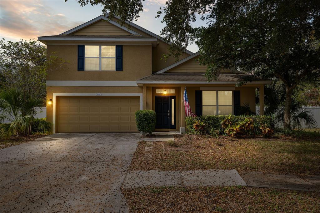 a front view of a house with a yard and garage