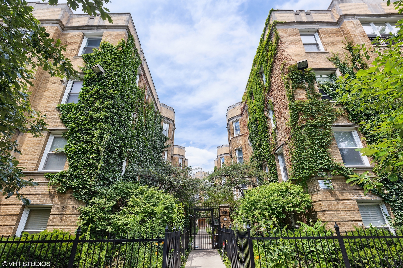 an aerial view of a residential apartment building with a yard and potted plants