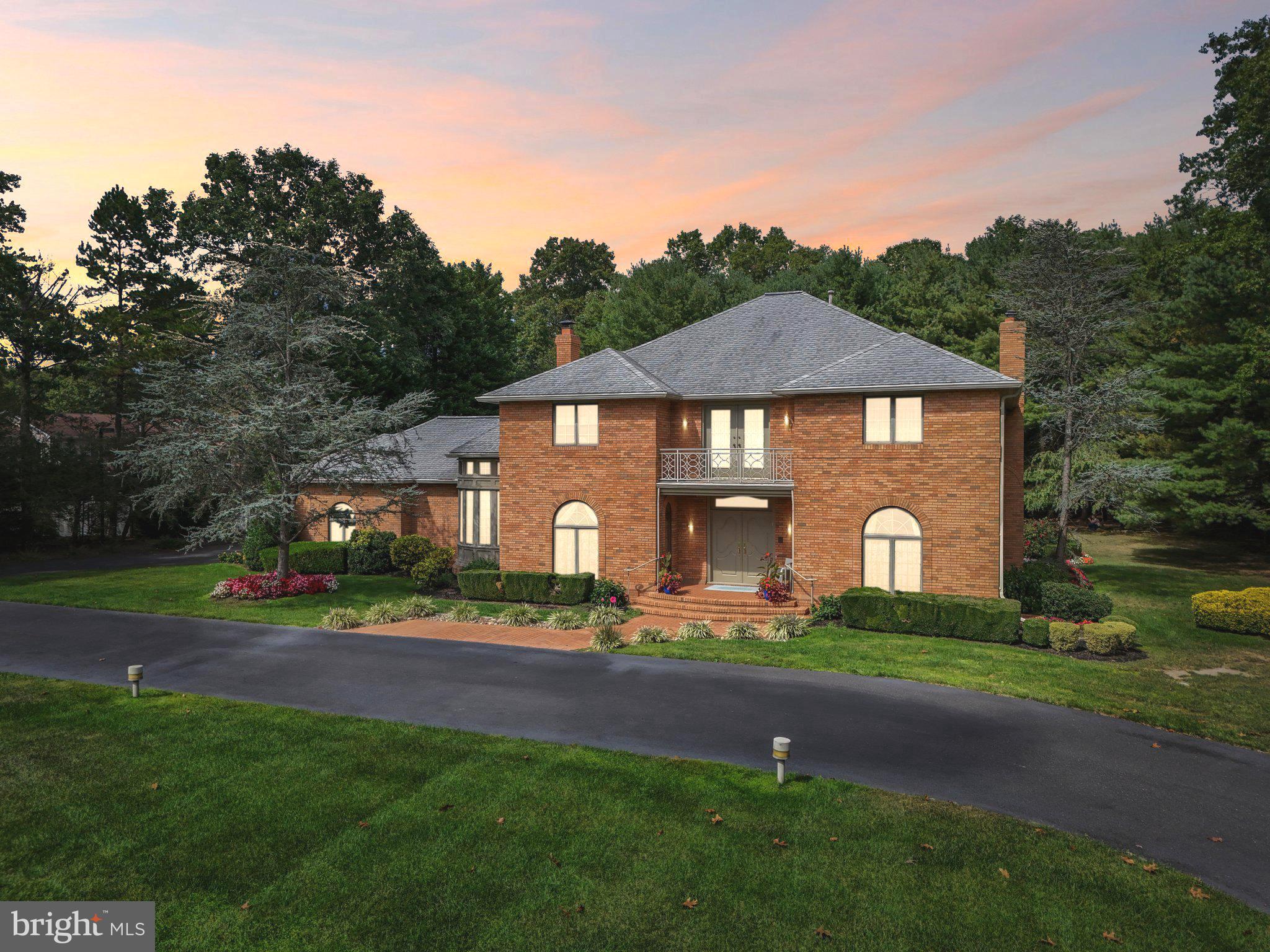 a front view of a house with a garden and yard