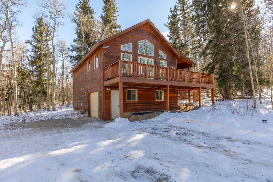 a view of a house with a yard covered with snow in front of house