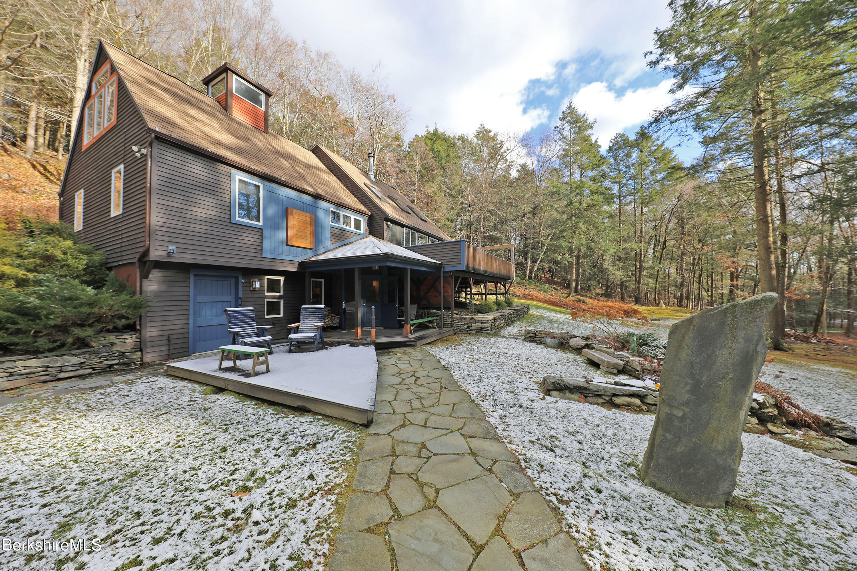 a front view of house with yard and sitting area